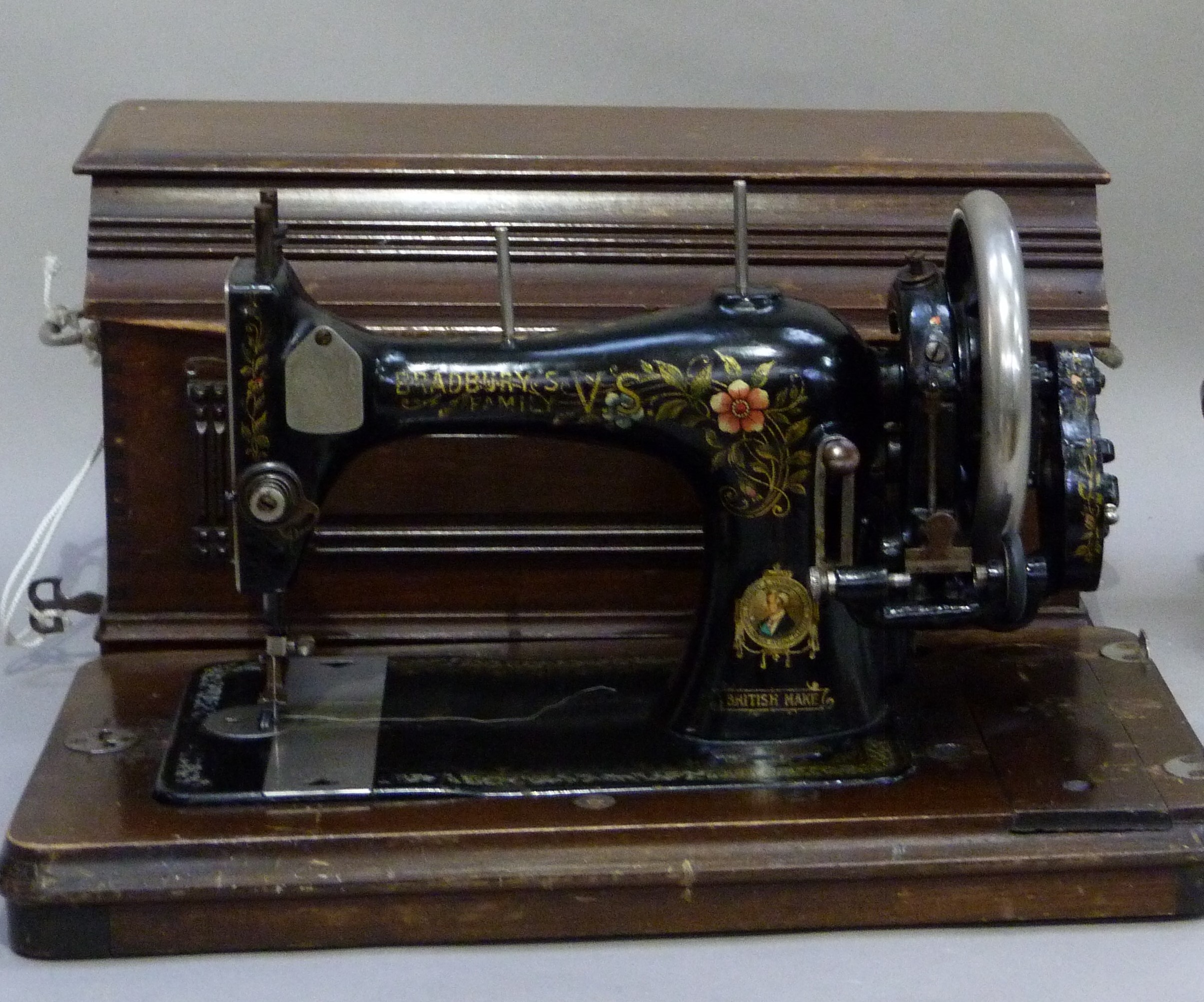 An early 20th century Bradbury's family sewing machine, black enamelled and printed in polychrome