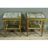 A pair of Italian style gilt and cream two tier tables the tops engraved with foliate scrolls on