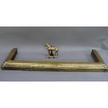 A brass fire kerb, together with a brass hearth ornament in the form of a horse