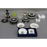 Five pieces of Wedgwood black jasper ware including, three lidded boxes and a pin tray, a Royal