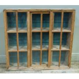 A Victorian pine glazed wall cabinet with sliding doors