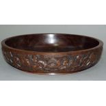 An African hardwood bowl the exterior carved with a continuous scene of figures, 34.5cm