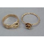 A buckle ring in 9ct gold scroll engraved to the front; together with a 9ct gold rose dress ring,
