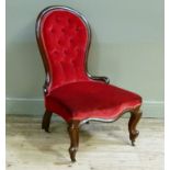A Victorian mahogany framed button back nursing chair with serpentine stuffed over seat and button