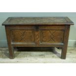 A late 17th century oak kist the hinged twin panelled top and front inlaid with geometric borders