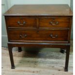 A George III style mahogany chest of two short and one long drawer on a stand with chamfered