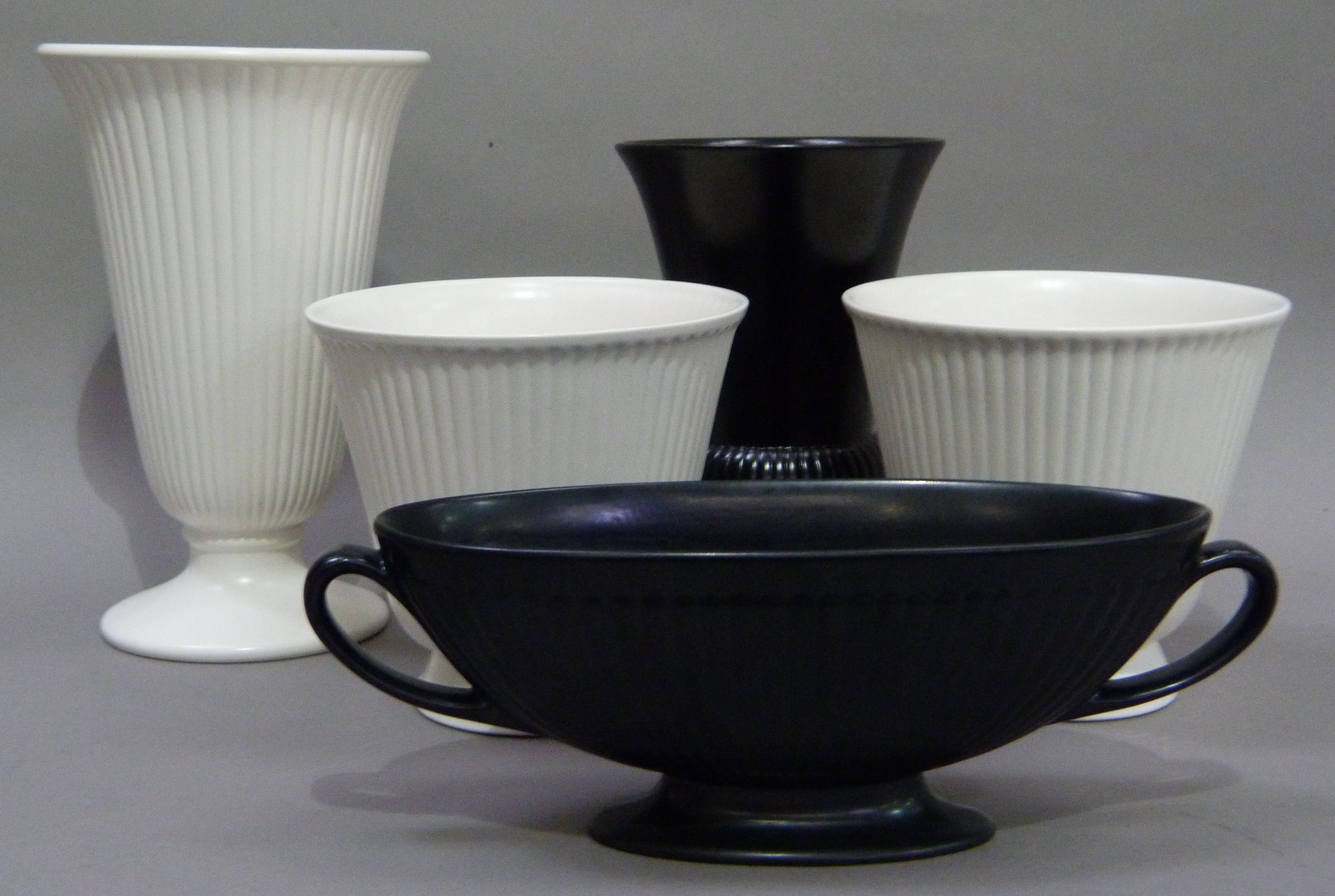 Five pieces of Wedgwood Etruria and Barlaston pottery including a pair of white reeded planters or