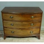 A regency mahogany chest of three long drawers, ebony strung within cross grained border, shaped