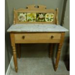 A late Victorian marble topped wash stand with tiled back fitted with one long drawer on turned