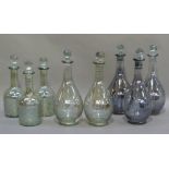 A pair of decanters with etched swagging and faceted stopper, 31.5cm, a further pair of similar