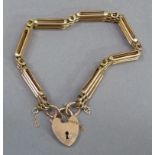 An Edward VII gate bracelet in 9ct rose gold, three bar with padlock fastener, approximate weight