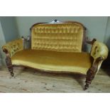 A Victorian walnut framed sofa, the buttoned back and arms and serpentine seat upholstered in yellow
