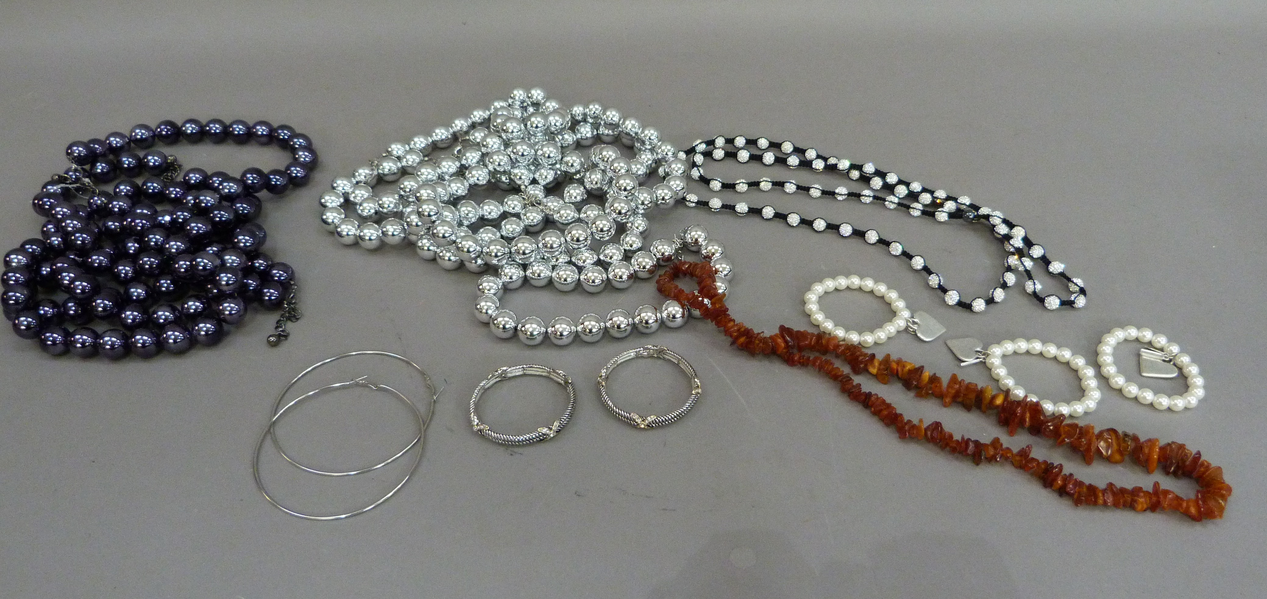 A quantity of costume jewellery including twelve necklaces of uniformed silver or blue beads,