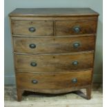 A Regency mahogany bow front chest of two short and three long graduated figured drawers, bowed