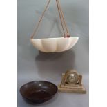 An Art Deco bakelite bowl, pink plastic ceiling light and a mottled ceramic cased clock