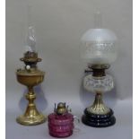 A Victorian oil lamp with faceted circular clear glass reservoir with waisted spreading circular