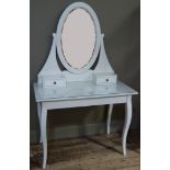 A white painted dressing table the oval mirror supported on a pair of small drawers, projecting base