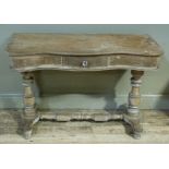 A Victorian stripped pine washstand base of serpentine outline the frieze fitted one short drawer