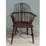 A 19th century ash and elm low back windsor elbow chair with pierced splat, dished seat on turned