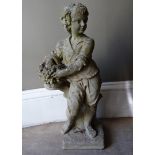 A reproduction concrete garden figure modelled as a young boy with basket of fruit, 74cm high