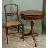 A reproduction mahogany small drum table the segmental circular top strung and crossbanded the