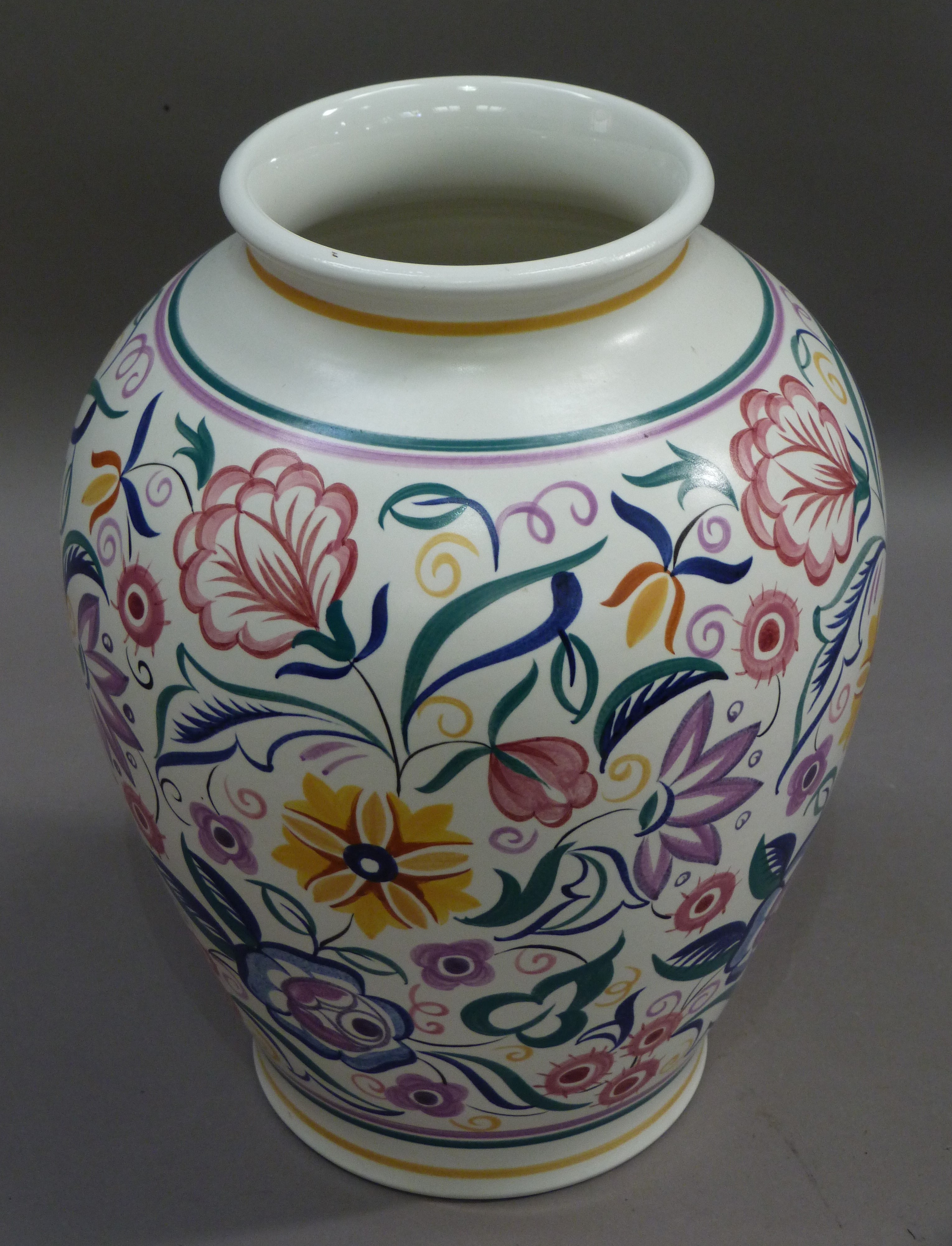 A large Poole pottery vase painted by K Hickisson in typical flower style, 34cm high