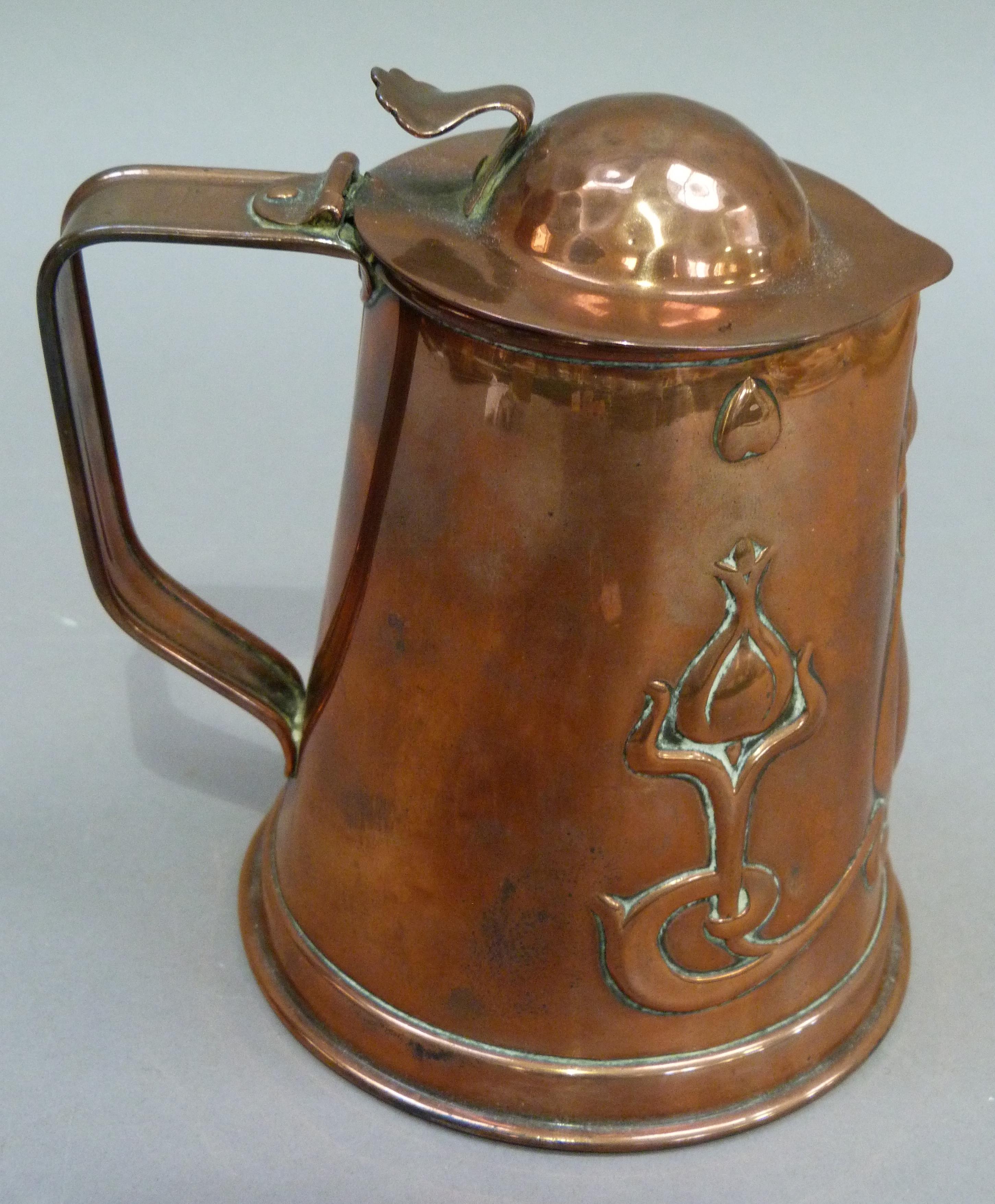 An Art Nouveau copper jug having a domed cover with thumb piece the tapered body embossed with - Image 3 of 3