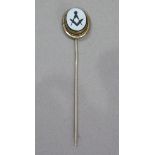 A late Victorian Masonic tie pin, the onyx intaglio collet set in an oval base metal surround