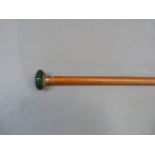 A walking cane with hardstone pommel with gilt metal engine turned mount and tapered stick
