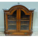 A 19th century walnut Dutch wall cabinet with arched cavetto cornice above a pair of shaped glazed