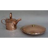 A copper water can and a circular disc bed warmer