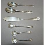 A small collection of silver cutlery including salt, mustard and teaspoons and a butter knife, total