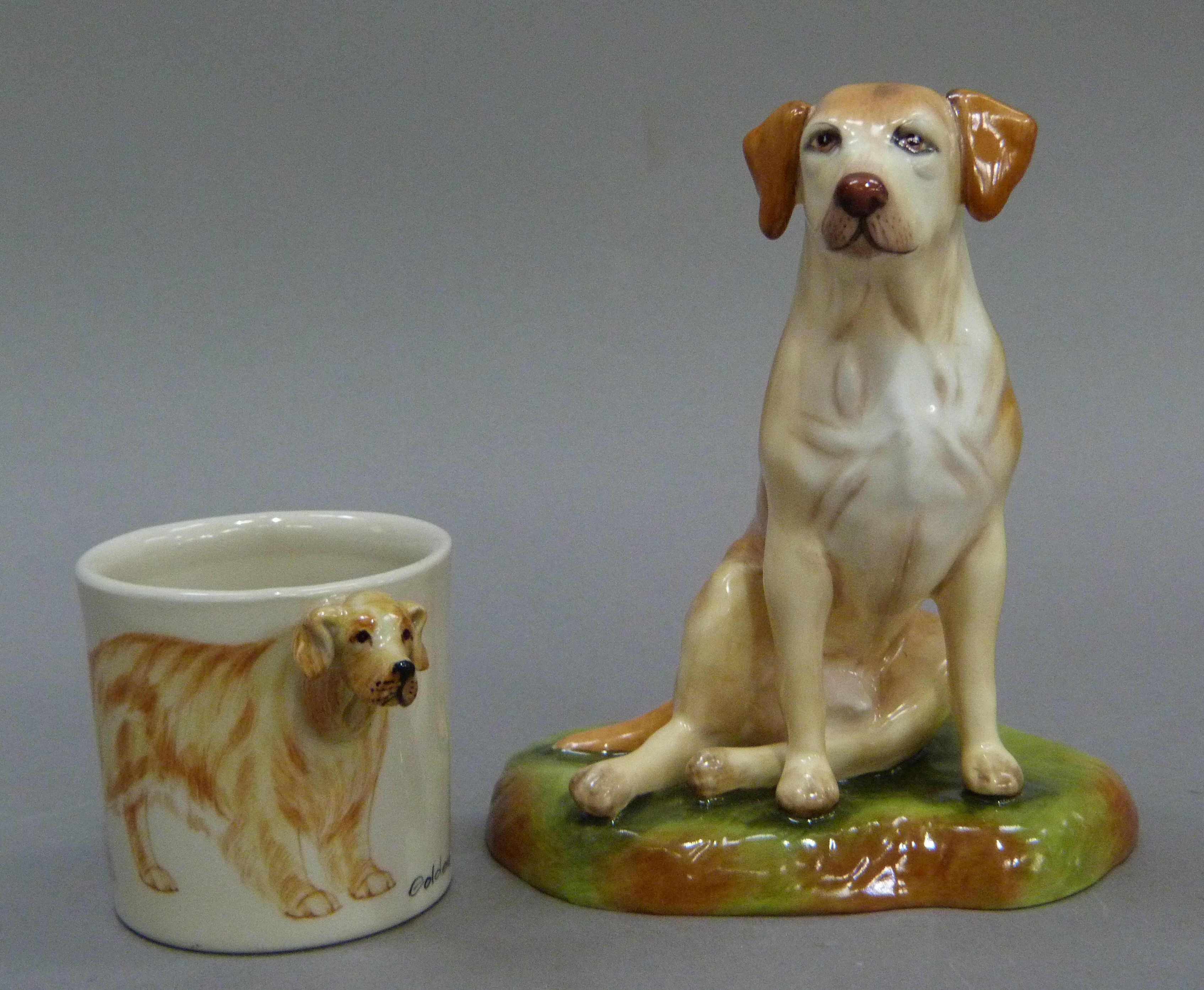 A china figure of a labrador by Royale Stratford together with a golden retriever mug the handle