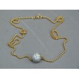 A bead pendant allover set with cubic zirconia hung on a bead chain in yellow metal (tests as 18ct