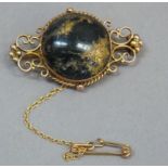 A Victorian brooch in 9ct gold, collet set to the centre with a circular cabochon of native gold