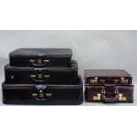 Two burgundy coloured brief cases; together with three vintage black leather suitcases (5)