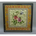 A Chinese needlework panel of peonies and songbird, framed