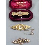 Three early 20th century bar brooches in 9ct gold, variously set with a small rose cut diamond