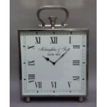 A reproduction steel framed oversized mantel clock with loop winder above a square dial inscribed