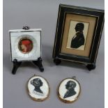 A pair of silhouettes depicting a young Queen Victoria and Prince Albert each initialled RE and in