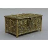 A Gothic style brass jewel casket cast with figures within trefoil arches, the interior lined with