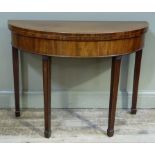 A George III mahogany tea table the D-shaped boxwood ebony strung and crossbanded above a deep