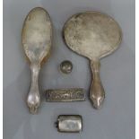 A silver backed hand mirror and hair brush, Chester 1921, a plain Vesta, Sheffield 1904, a silver