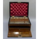 A Victorian walnut workbox the hinged lid with recessed brass carrying handle the interior with