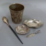 A sterling silver beaker, silver travel book mark, two pin trays etc