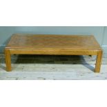 An elm rectangular coffee table on square legs, 137cm x 62cm x 39cm