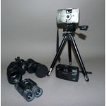 Two digital by cameras by Minolta, a pair of Tasco folding binoculars, a tripod and instruction