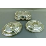 A pair of silver plated entree dishes and covers, oval with laurel leaf handles; together with a