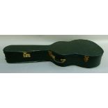 A vintage guitar case in black (containing a guitar which is at fault)