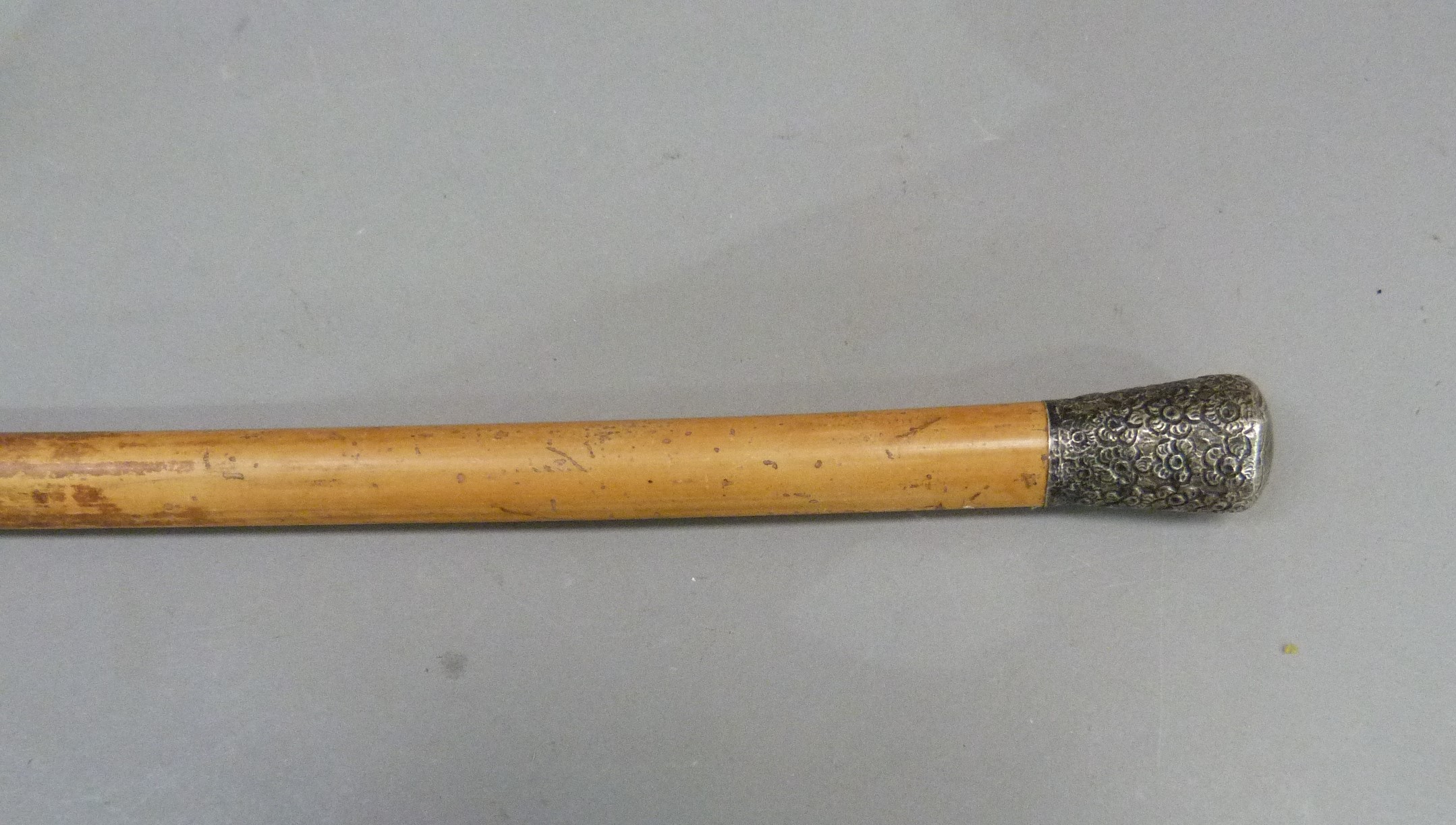 A gentleman's walking cane, the silver foliate embossed pommel above a tapered stick - Image 2 of 2